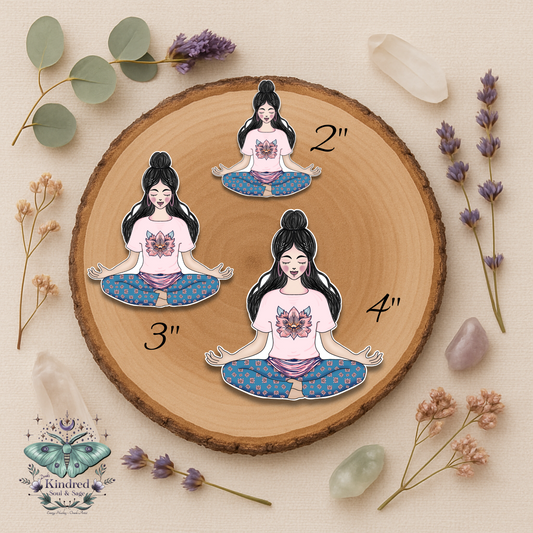 Wooden round board with illustrations of a woman in a yoga pose, surrounded by dried flowers and crystals.