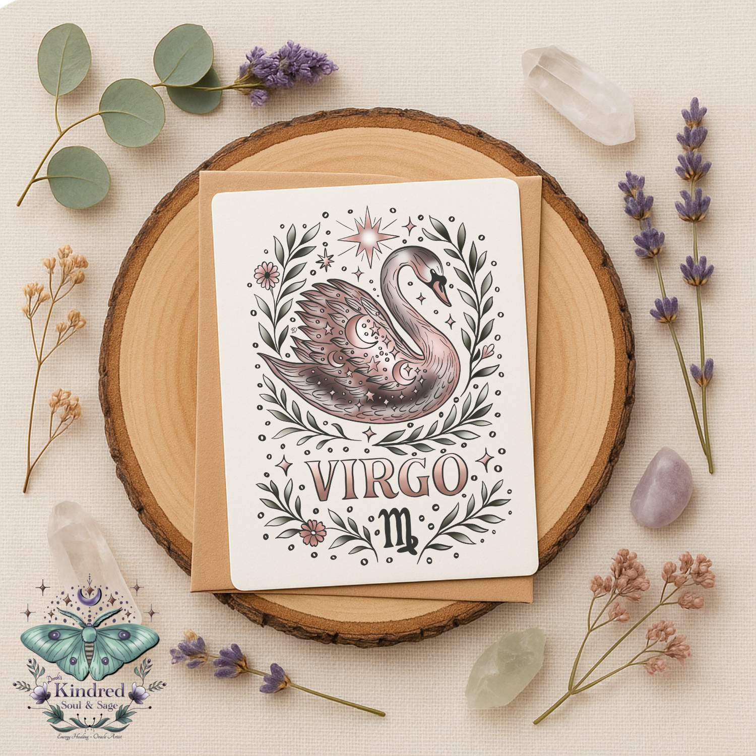 Card with swan illustration and 'Virgo' text on a wooden round surface with flowers and crystals.